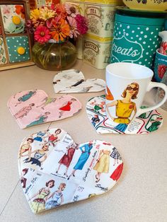 several heart shaped plates and cups on a counter