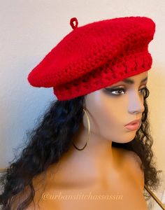 a mannequin head wearing a red knitted hat