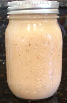 a glass jar filled with liquid sitting on top of a counter