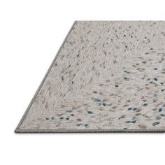 a white rug with blue dots on the top and bottom, against a white background