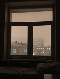 an open window with city lights in the background