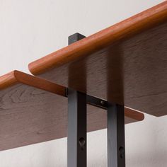 a close up of a wooden shelf with metal brackets on the bottom and wood top