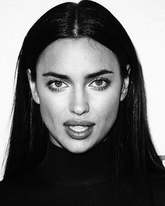 a black and white photo of a woman with long hair wearing a turtle neck sweater