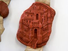 a piece of red clay sitting on top of a table