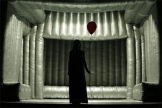 a woman standing in front of an inflatable balloon with the caption valentine's day written on it