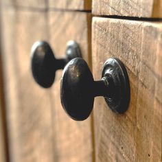 the handles and knobs on this wooden cabinet are black