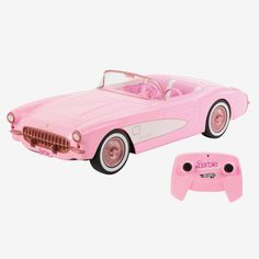 a pink toy car next to a game controller