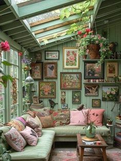 a living room filled with lots of furniture and pictures on the wall above it's windows