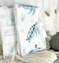 two pillows with sea turtles on them are next to each other and the label says, bitty