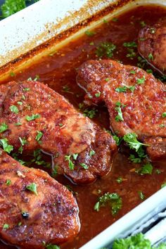 three pieces of meat covered in sauce and garnished with parsley