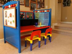 a child's play table and chairs in a room