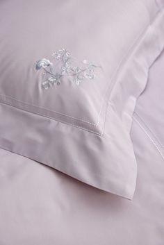 a close up of a pillow on a bed