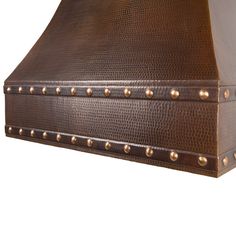 a brown leather covered box with rivets on the sides