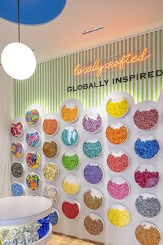 there are many different colored cereals in bowls on the wall