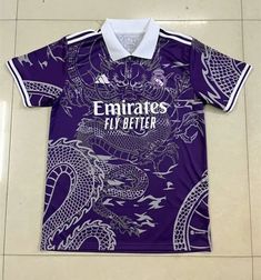 a purple shirt with an image of a dragon and the words emirates fly better on it