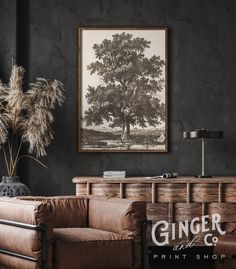 a living room with a couch, chair and painting on the wall above it that says ginger print shop