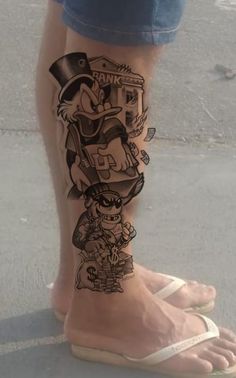 a person's legs with cartoon tattoos on them