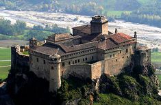 an old castle sitting on top of a mountain