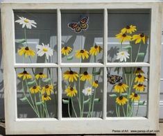 an old window is decorated with butterflies and daisies