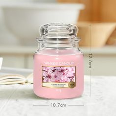 a pink candle sitting on top of a table