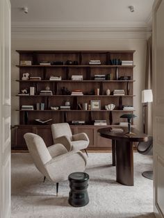 a living room filled with furniture and bookshelves