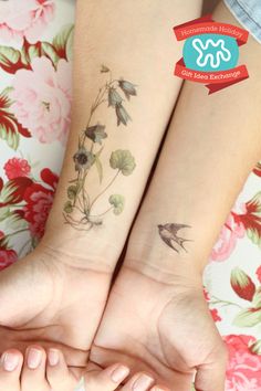 two matching tattoos on the arms of women with flowers and birds tattooed on their arm