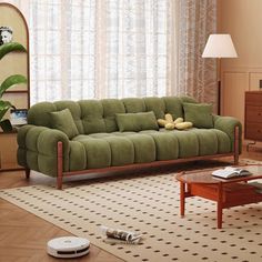 a living room with a green couch and coffee table