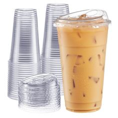 several plastic cups with drinks in them on a white background and one is filled with ice