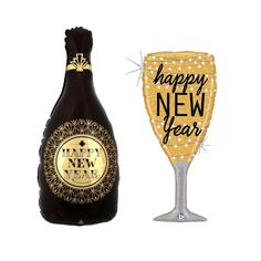 a new year's eve champagne glass next to a happy new year wine bottle