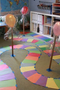 there are many balloons on the floor in this classroom area, and it is fun to play with