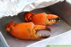 two cooked lobsters sitting on top of a metal pan