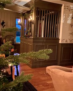 a living room filled with furniture and a christmas tree