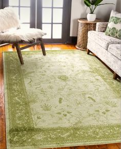 a living room with a green rug on the floor and a white chair in front of it