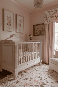 a baby's room with a crib, couch and pictures on the wall