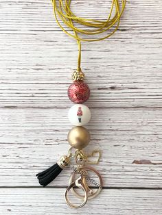 This listing is for one Nutcracker Beaded Lanyard.  Made with a lobster clasp for badges, keyring, beautiful acrylic beads, tassel, charm, and comfortable, strong cord.   Breakaway clasp will be included for you to add on at your desired length - very easy to do. I do not put the clasp on - this is so you can put it on the cord at the desired length you need. Instructions will be included.)  Cord length comes at approximately 46". If you would like me to put the breakaway clasp on please leave me a note at checkout and the length you would like the lanyard to hang. Comes in an organza gift bag. Ready to ship in one business day. Please message me with any questions or special requests. DISCLAIMER - Parental warning: These are not recommended for children under the age of 3. This is not a t Christmas Bead Lanyard, Neaded Necklace With Tassels On Lanyard Cord, Christmas Beaded Lanyard, Beautiful Beaded Necklaces, Lanyard Necklace, Beaded Lanyard, Bead Projects, Beaded Lanyards, Chunky Beads