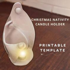 a christmas nativity candle holder is shown with the light in it's center