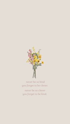 a bouquet of flowers sitting on top of a white wall next to a quote that reads,