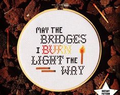 a cross stitch pattern with the words may the bridges burn, light the way on it