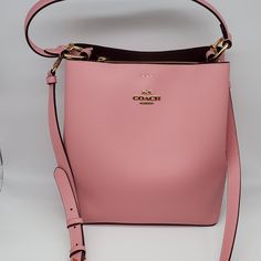 Brand: Coach Style: Town Bucket Bag / 91122 Condition: New With Tag Exterior Color: Bubblegum/Wine Interior Features: Center Zip Compartment Closure: Magnetic Snaps Hardware Color: Gold Straps: One Short Handle And One Crossbody/Shoulder Strap Approx. Measurements: 10.25" L X 10" H X 5" W Includes: Coach Hangtag No Lowball Offers Or Trades Please. Thank You For Looking! Pink Bucket Satchel With Top Carry Handle, Pink Bucket Bag With Top Carry Handle, Pink Crossbody Bucket Bag With Top Carry Handle, Luxury Pink Bucket Bag With Top Carry Handle, Modern Pink Bucket Bag With Detachable Strap, Pink Bucket Bag With Detachable Handle For Formal Occasions, Pink Formal Bucket Bag With Detachable Handle, Formal Pink Bucket Bag With Detachable Handle, Formal Pink Top Handle Bucket Bag