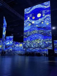 the starry night painting is projected in an open space