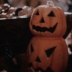 two carved pumpkins sitting next to each other