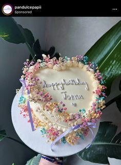 a heart shaped cake with the words happy birthday jenny written on it in white frosting