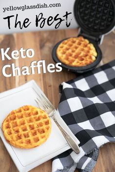 two waffles sitting on top of a white plate next to a black and white checkered napkin