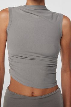 Fitted Modal Camisole Tank Top, Summer Tops With Ruched Sides And Elastane, Versatile 4-way Stretch Tank Top, Flattering Fitted Sleeveless Top, Versatile Fitted Cami Tank Top, Seamless Fitted Tank Top For Layering, Fitted Seamless Tank Top For Layering, Spring Fitted Seamless Tank Top, Stretch Ruched Tank Top