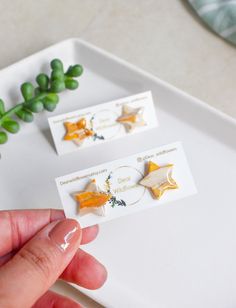 "Beautiful Gold Star Studs add a pop of color to any outfit! Beautiful in every angle, they make the perfect gift! Handmade with a special blend of polymer clay to bring this beautiful, marbled slab to life. Gold detailing enhances the design, and a resin topcoat completes these beautiful earrings. Stainless Steel posts make them Hypoallergenic and hard to tarnish. Size: 3/4\" x 3/4\" Material: Polymer Clay, Resin, Stainless Steel Love this Style? Check out our other Beautiful Designs in Shop! https://www.etsy.com/shop/DearWildflowers Super Lightweight and comfortable to wear, you won't even notice you are wearing them! Perfect Earrings to dress up any outfit and make it your own, because if jewelry should be anything, is Personal! Raw Brass can tarnish over time if not kept in Clean and i Polymer Clay Star, Clay Star, Polymer Clay Resin, Star Earring, Earring Gold, Minimal Jewelry, Hypoallergenic Earrings, Star Studs, Gold Star