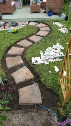 a stone path in the middle of a yard