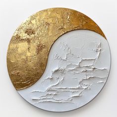 a white and gold plate with a map in the shape of a yin - yang