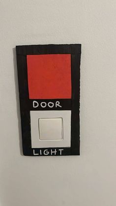 a light switch with a red and black door on it