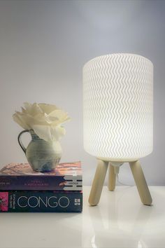 A wave inspired 3D printed lamp on a nightstand with come books. 3d Printed Lamp, Japanese Word, Unique Lamp, General Lighting, Japanese Words, Eye Care, A R