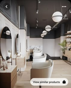 the interior of a hair salon with chairs, mirrors and lights hanging from the ceiling